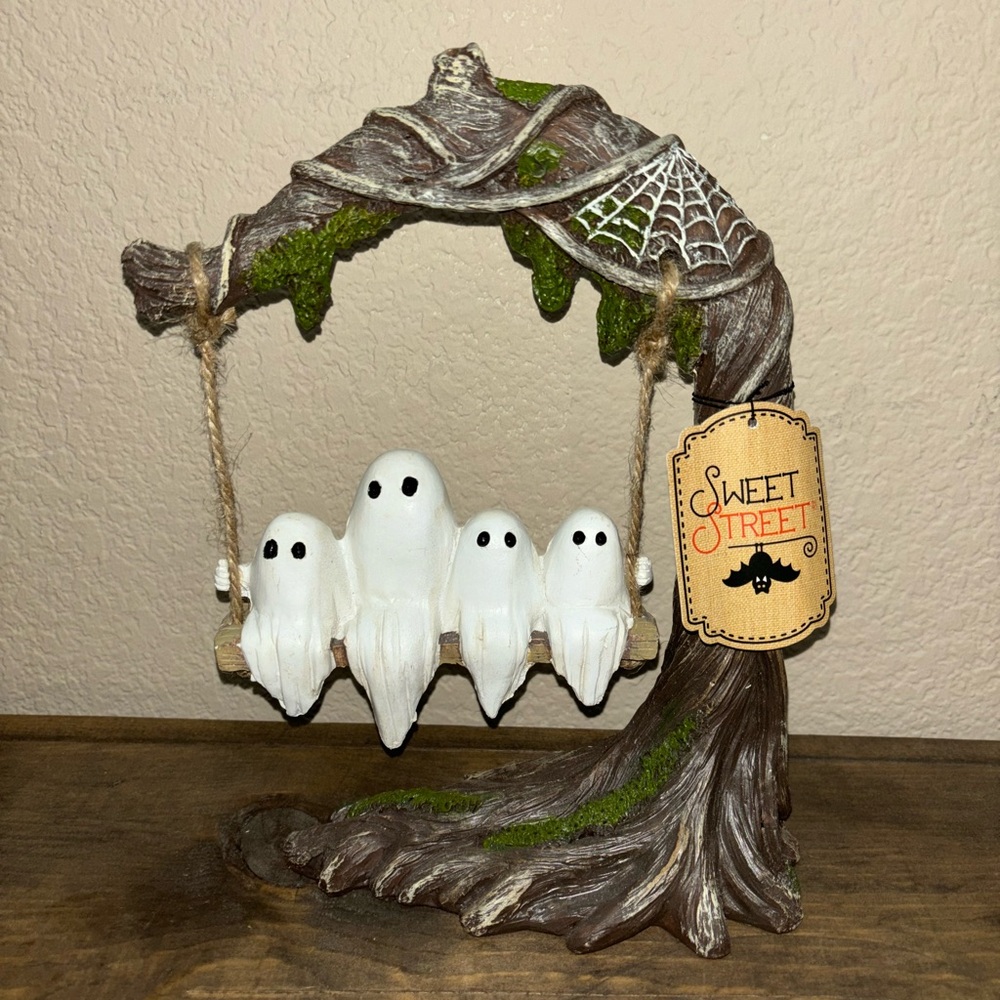 ghost family swinging in tree